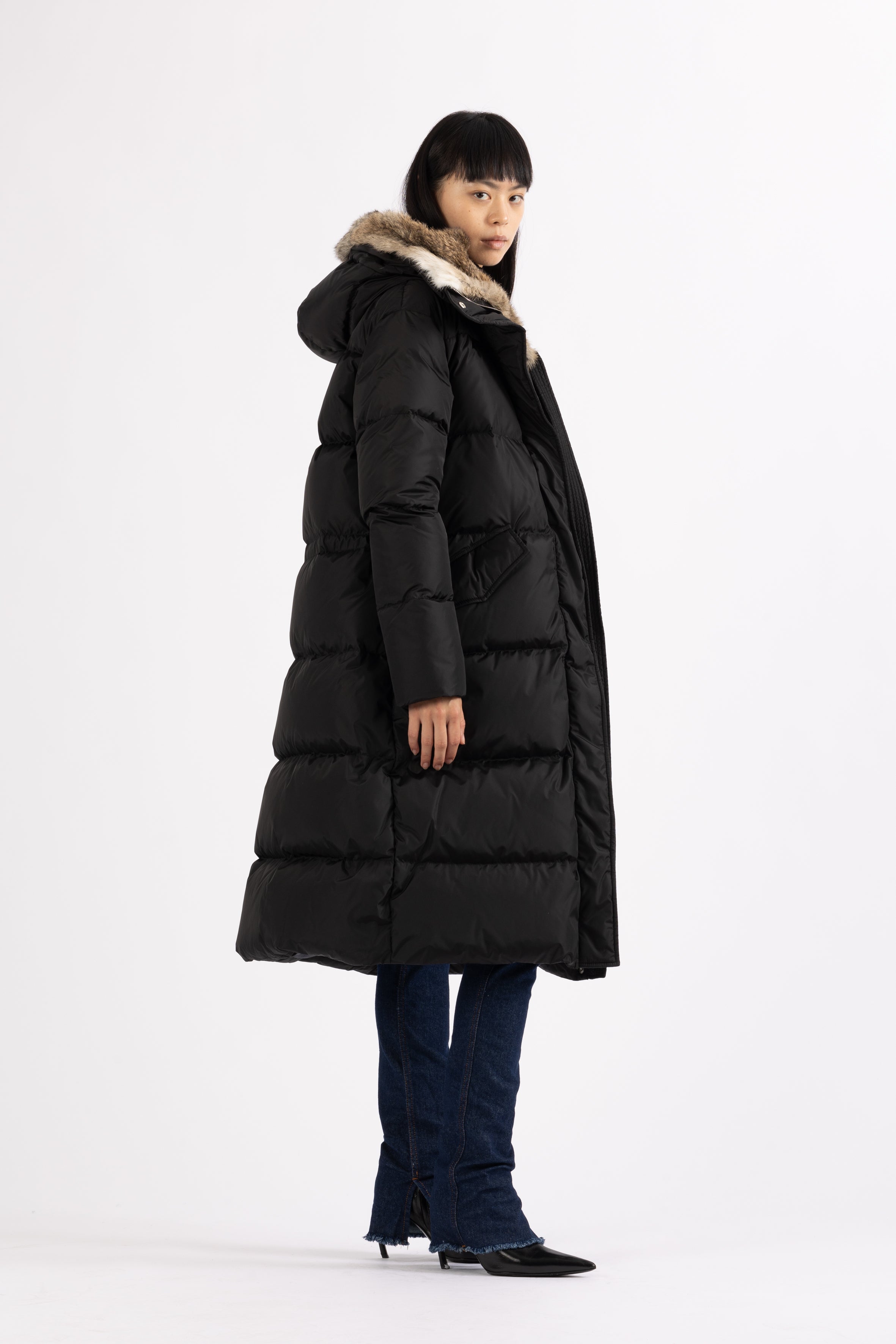 Long Lempelius Downcoat with a slim, slightly flared silhouette in back
and hood with extra soft, removable rabbit fur