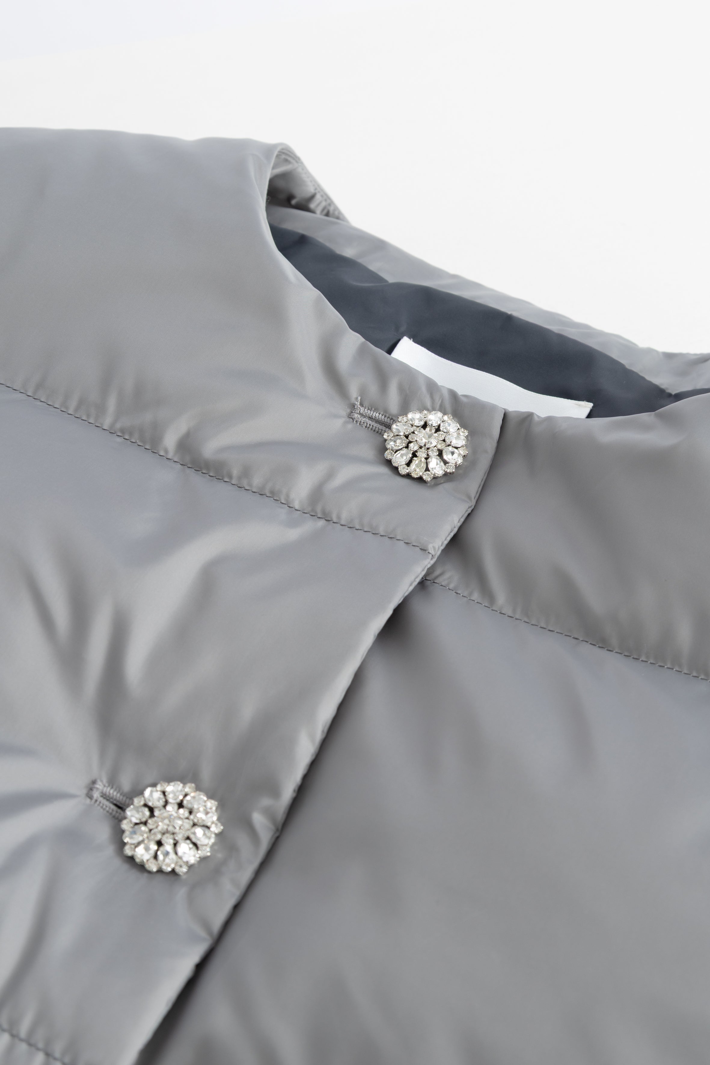 Gray designer jacket with decorative buttons on a white background