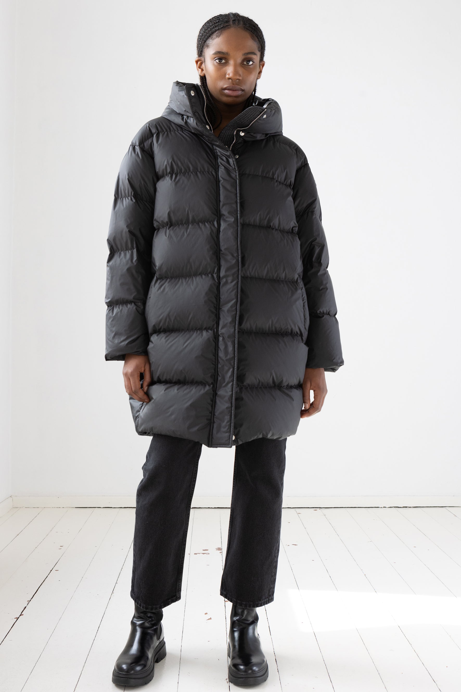Mid‑length down parka with a cocoon shaped silhouette