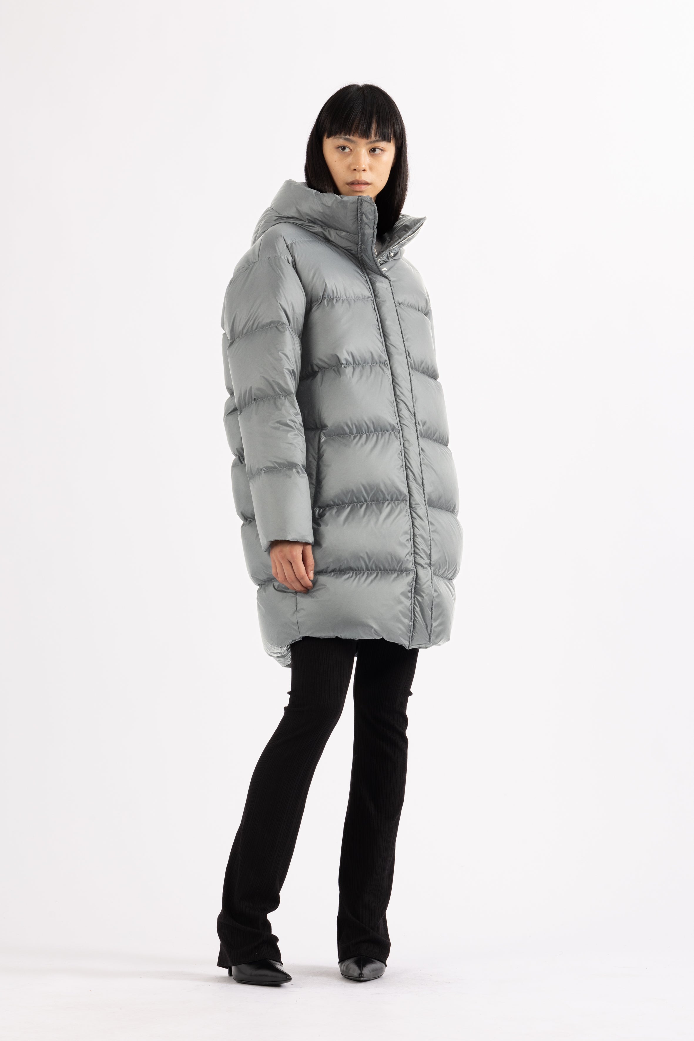 Mid‑length down parka with a cocoon shaped silhouette