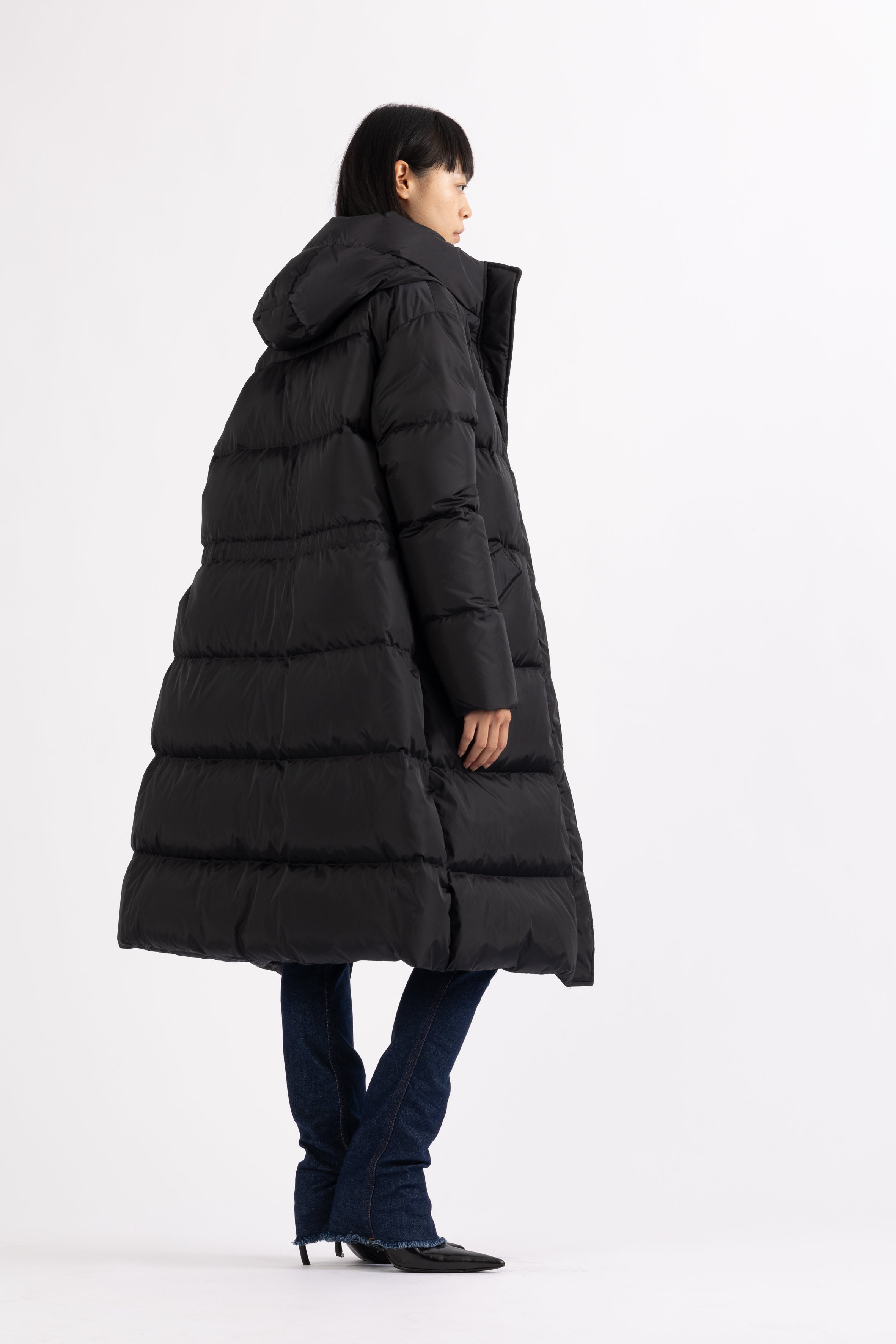 Long Lempelius Downcoat with a slim, slightly flared silhouette in back