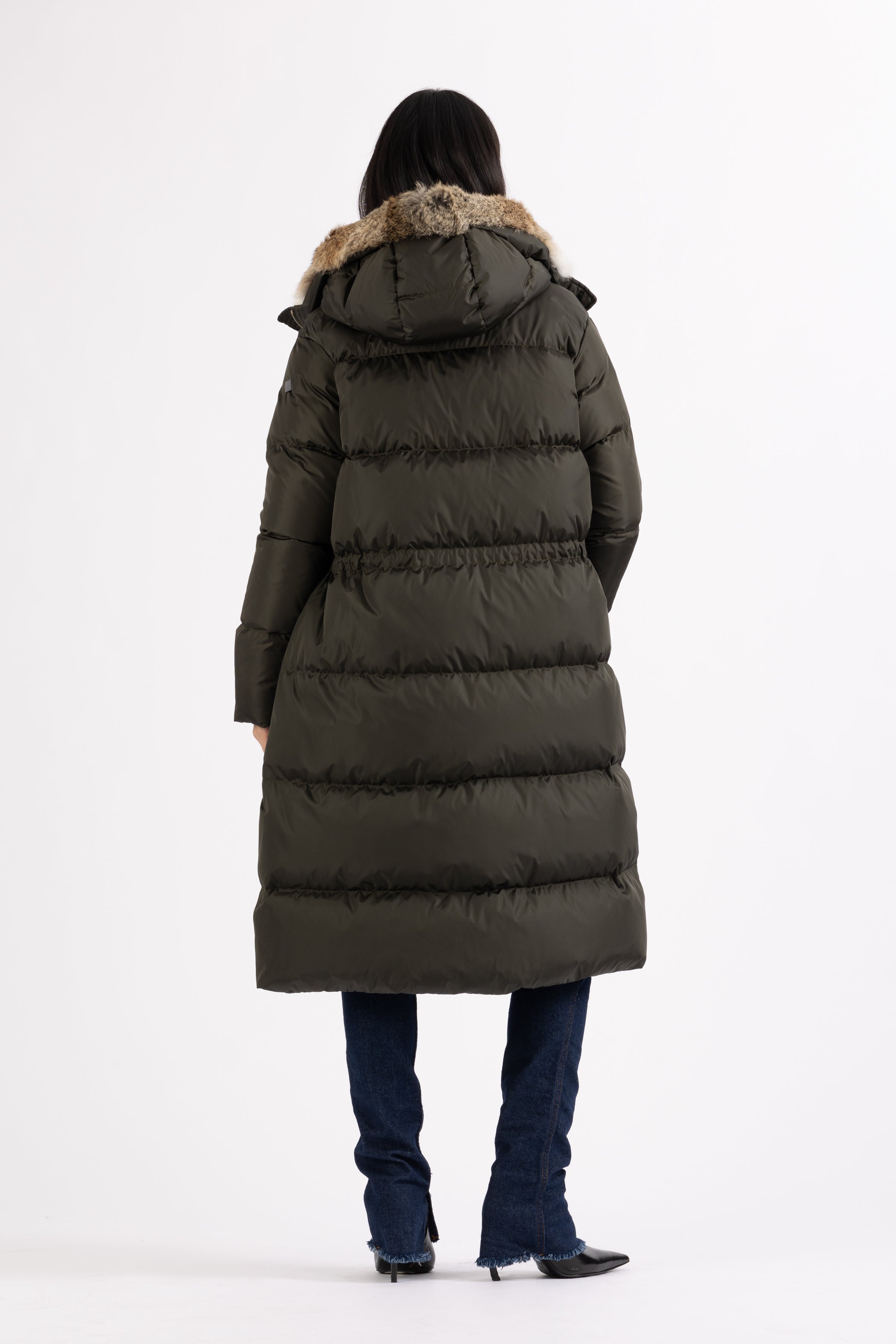 Long Lempelius Downcoat with a slim, slightly flared silhouette in dark green
and hood with extra soft, removable rabbit fur