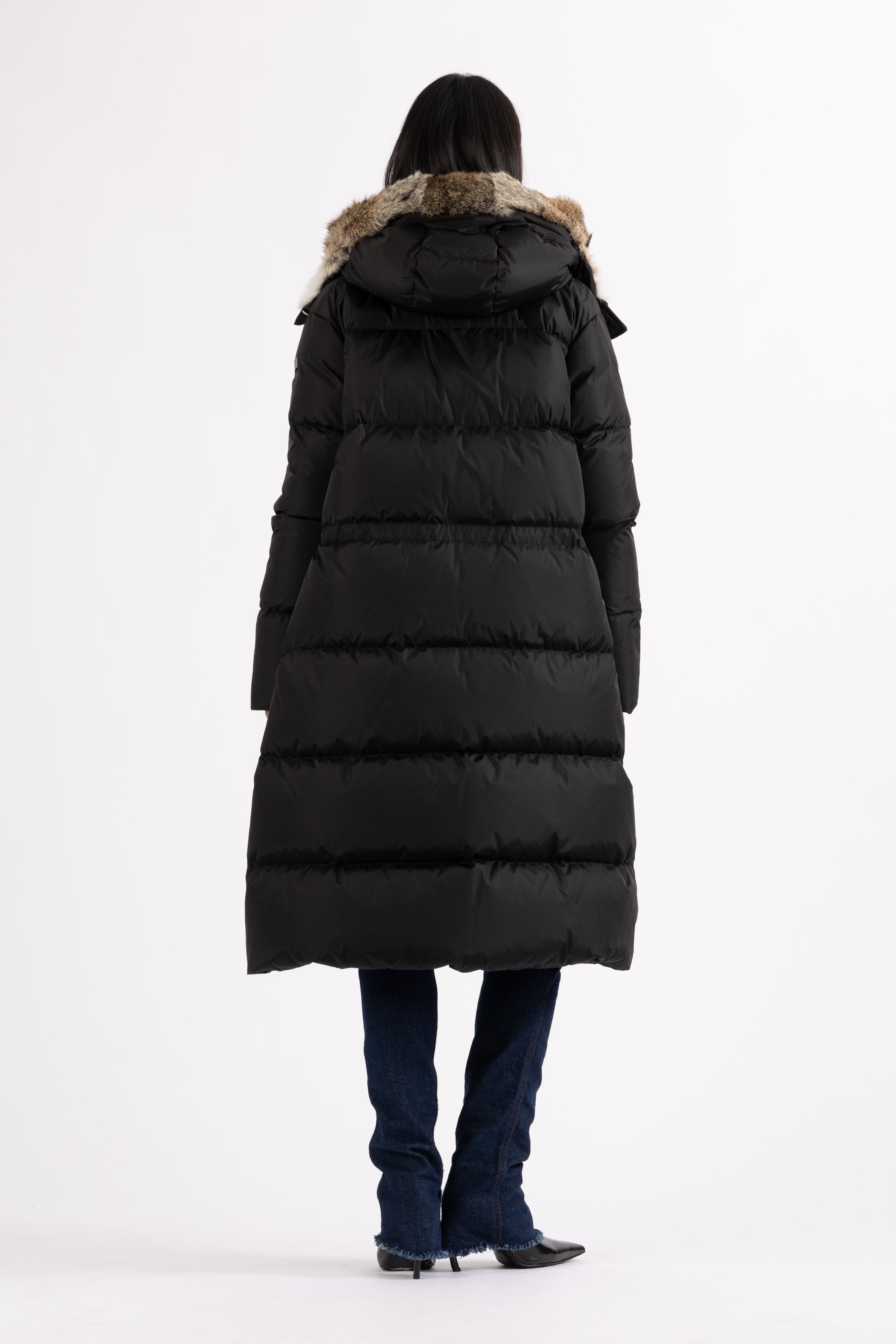 Long Lempelius Downcoat with a slim, slightly flared silhouette in back
and hood with extra soft, removable rabbit fur