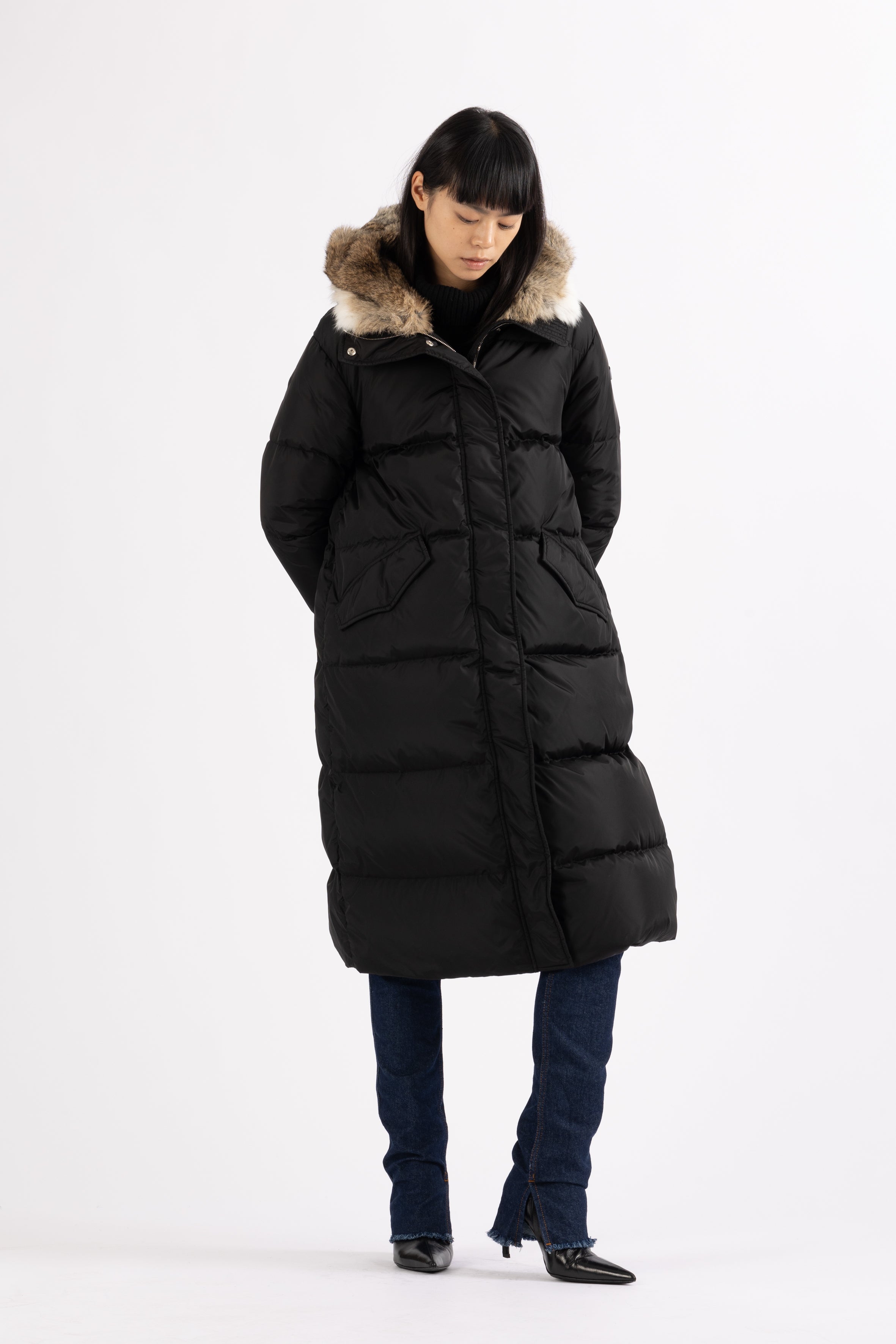 Long Lempelius Downcoat with a slim, slightly flared silhouette in back
and hood with extra soft, removable rabbit fur