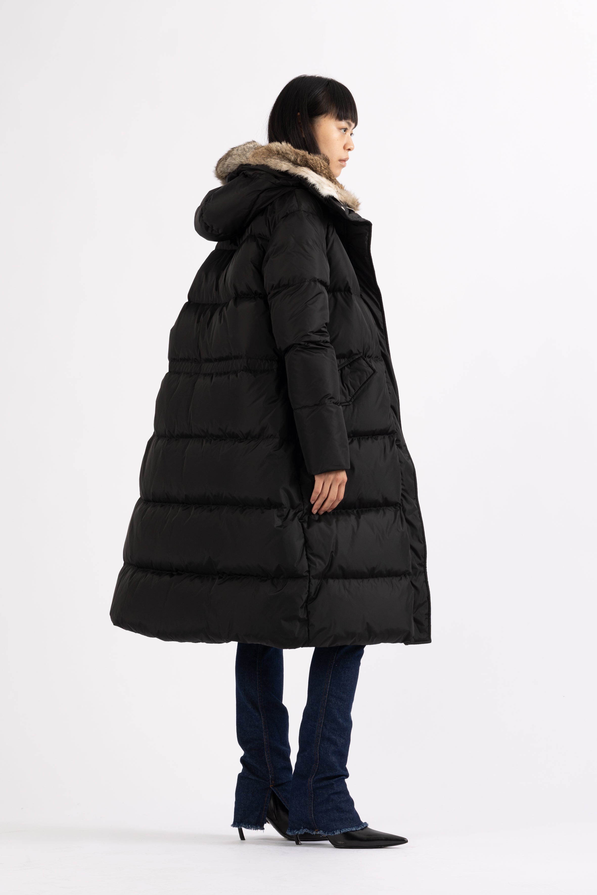 Long Lempelius Downcoat with a slim, slightly flared silhouette in back
and hood with extra soft, removable rabbit fur