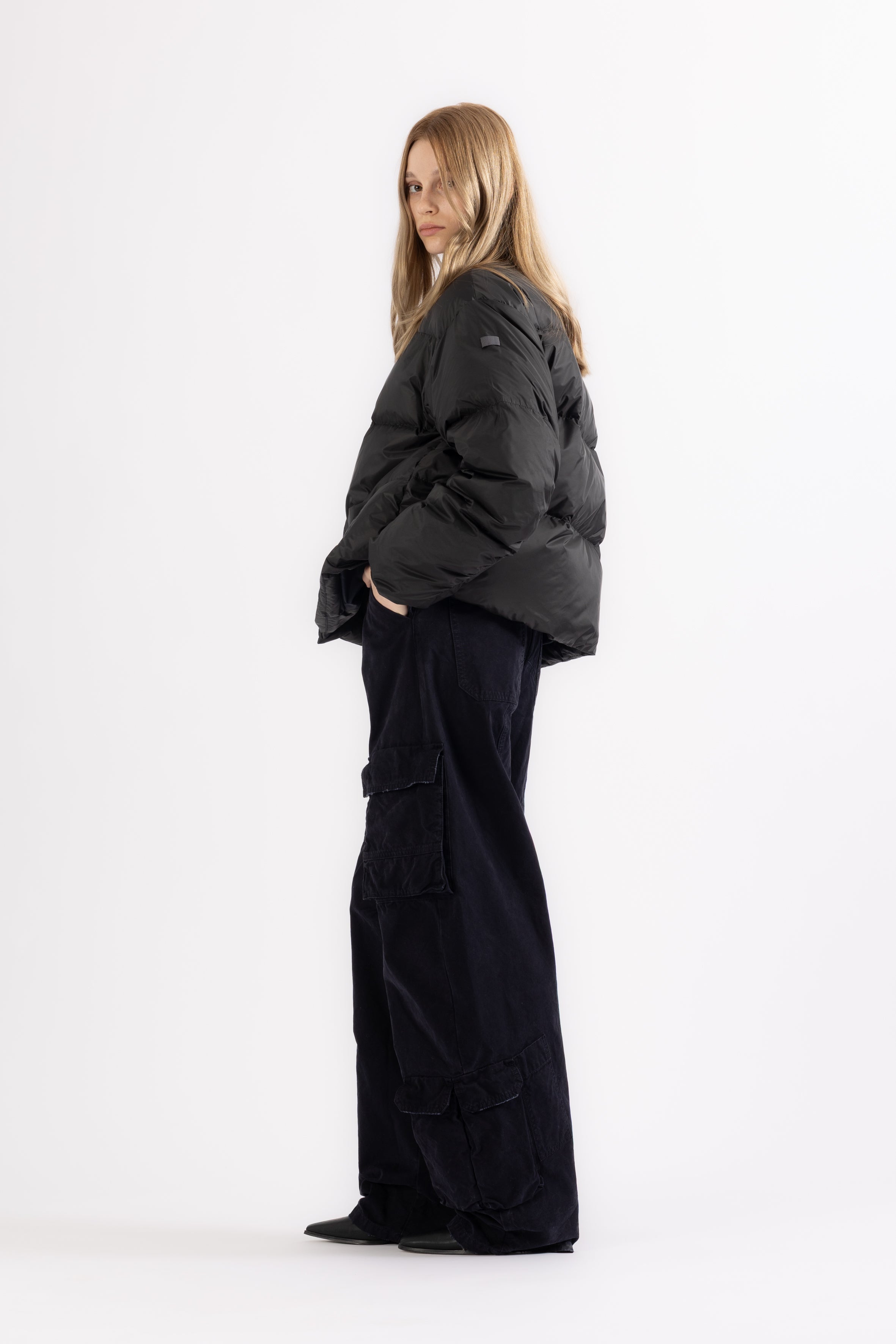 Woman wearing a black LEMPELIUS down jacket on white background